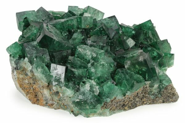 A cluster of highly fluorescent, green fluorite from the Weardale area of England.